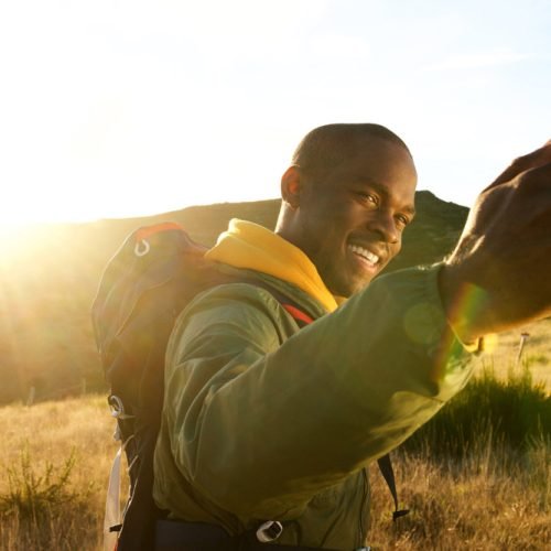 happy-young-african-american-man-hiking-in-mountai-2023-11-27-05-27-52-utc.jpg